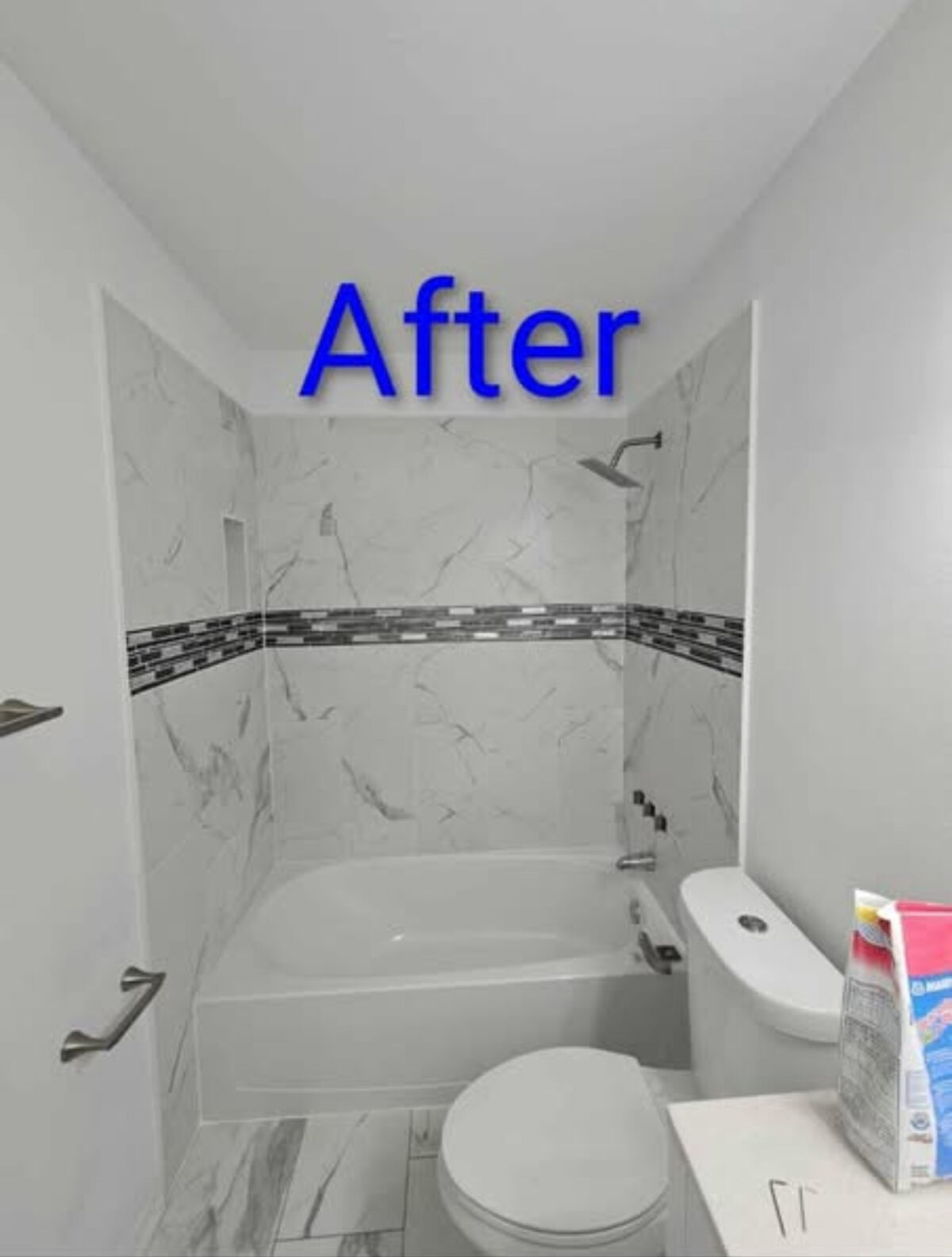 Bathroom after remodel with marble-look tile shower surround