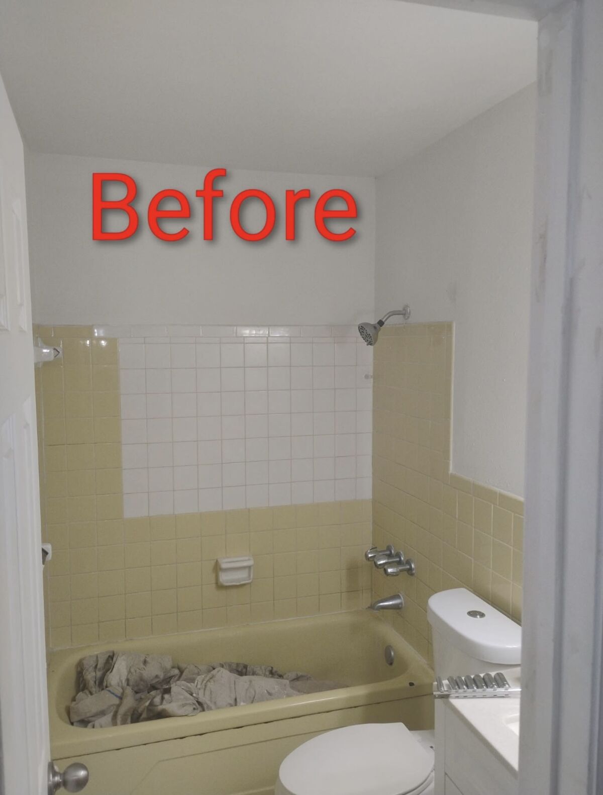 Bathroom before remodel with dated yellow tile and tub