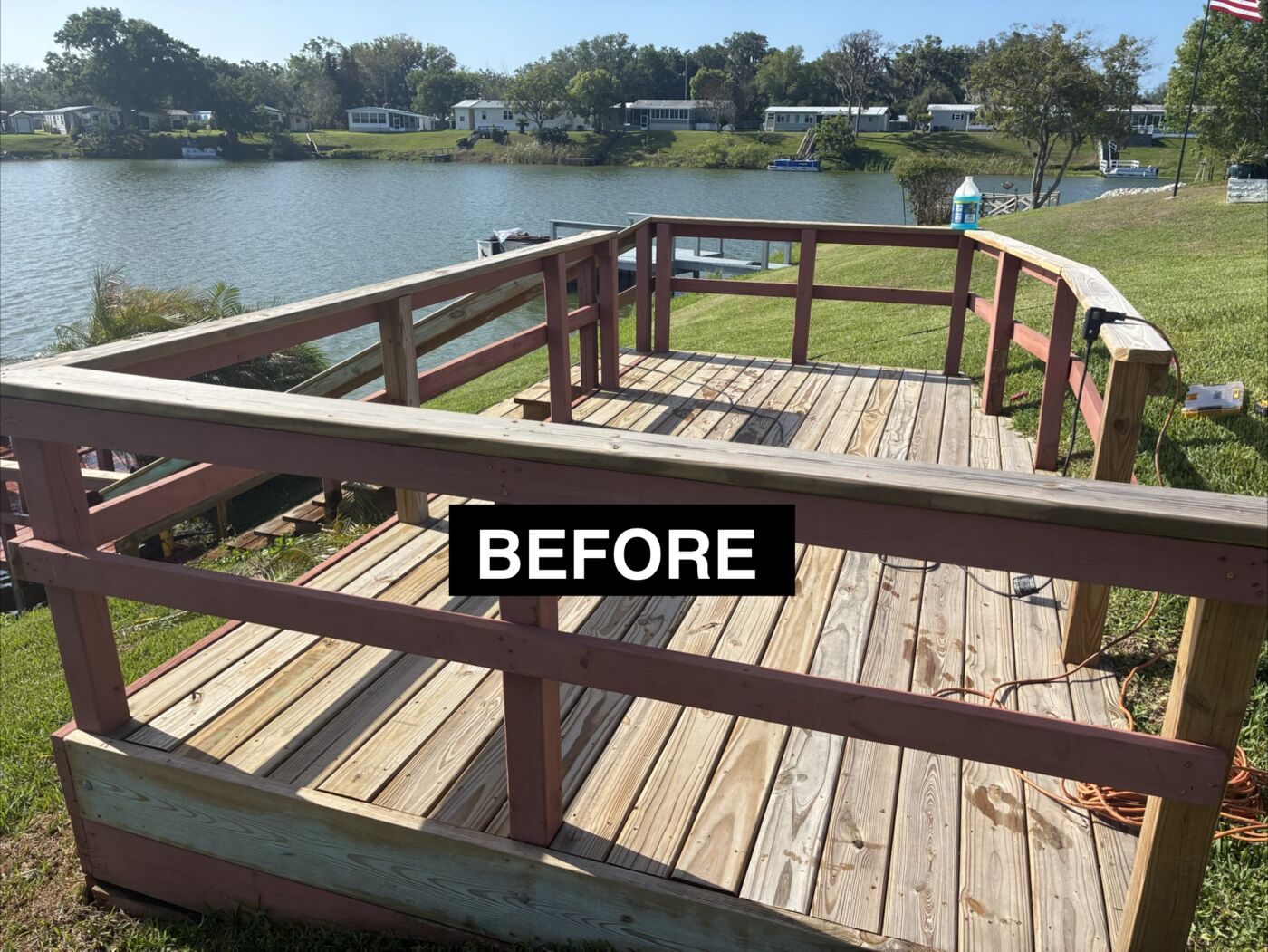 Weathered lakeside deck boards and railing before rebuild