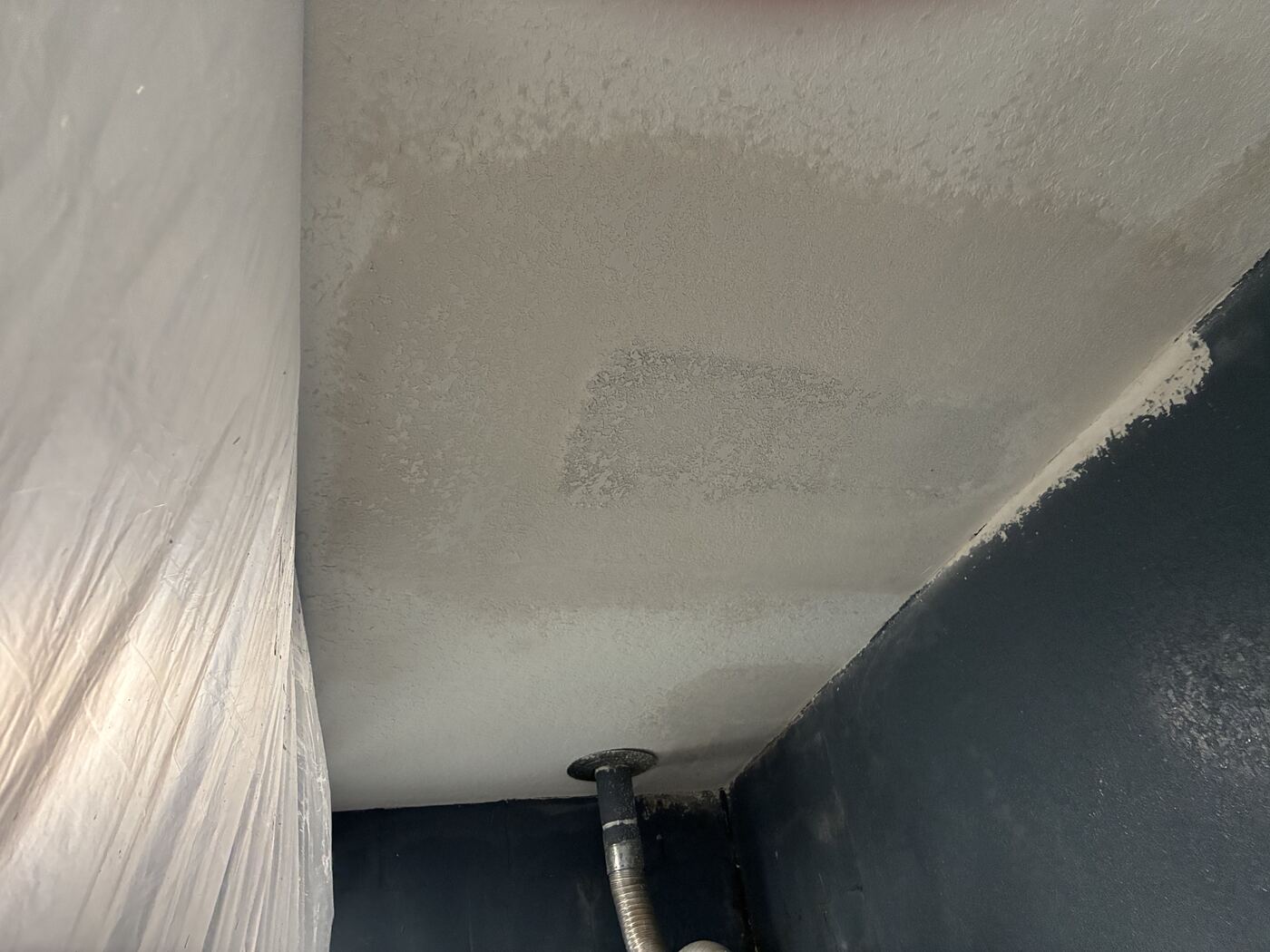 Ceiling drywall repair in progress, finished smooth